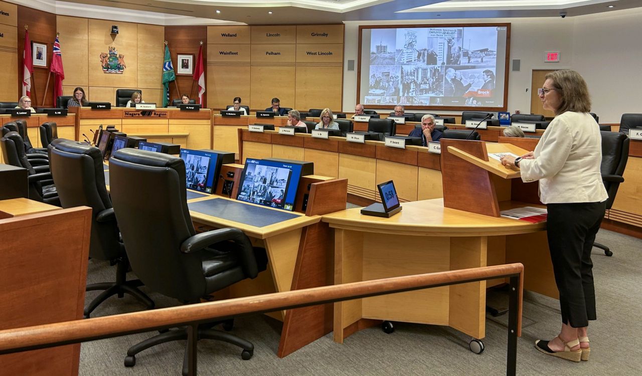 A woman speaks to a local government council from a podium.