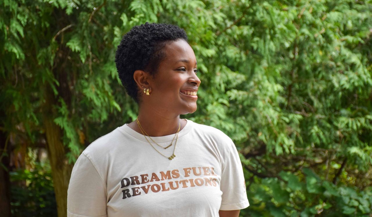Tanika Hillocks, wearing a shirt that reads “Dreams fuel revolutions”.
