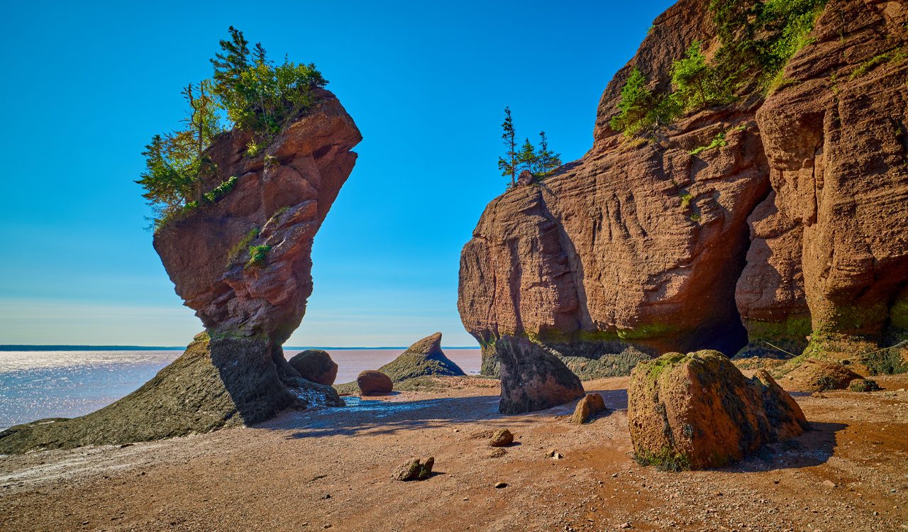 Brown rocks in the shape of a flowerpot, known as Hopewell Rocks in Nova Scotia's Bay of Fundy.