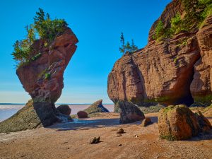 Brown rocks in the shape of a flowerpot, known as Hopewell Rocks in Nova Scotia's Bay of Fundy.