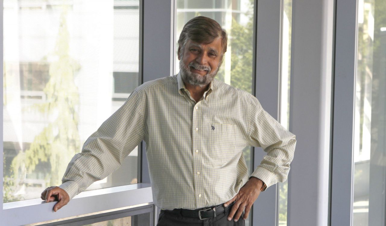 A man stands in a university hallway.
