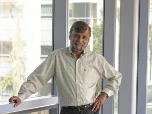 A man stands in a university hallway.