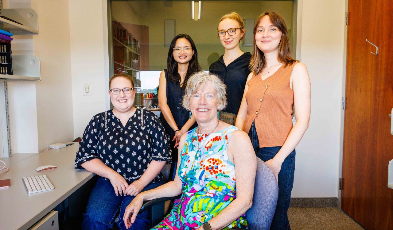 Cathy Mondloch and research team in a brightly lit office in Brock’s Face Perception Lab.