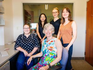 Cathy Mondloch and research team in a brightly lit office in Brock’s Face Perception Lab.