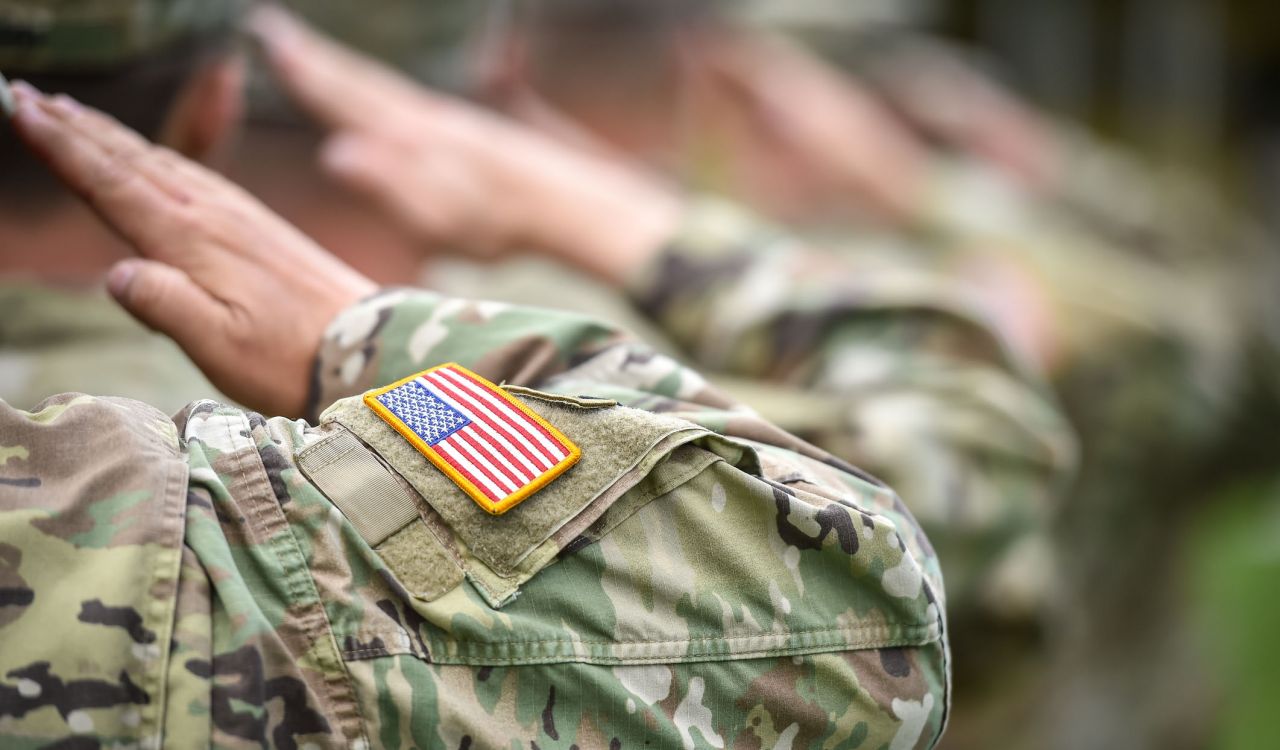 Close-up of the arms of people wearing U.S. military uniforms.