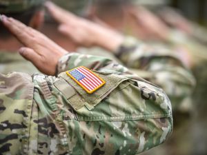 Close-up of the arms of people wearing U.S. military uniforms.