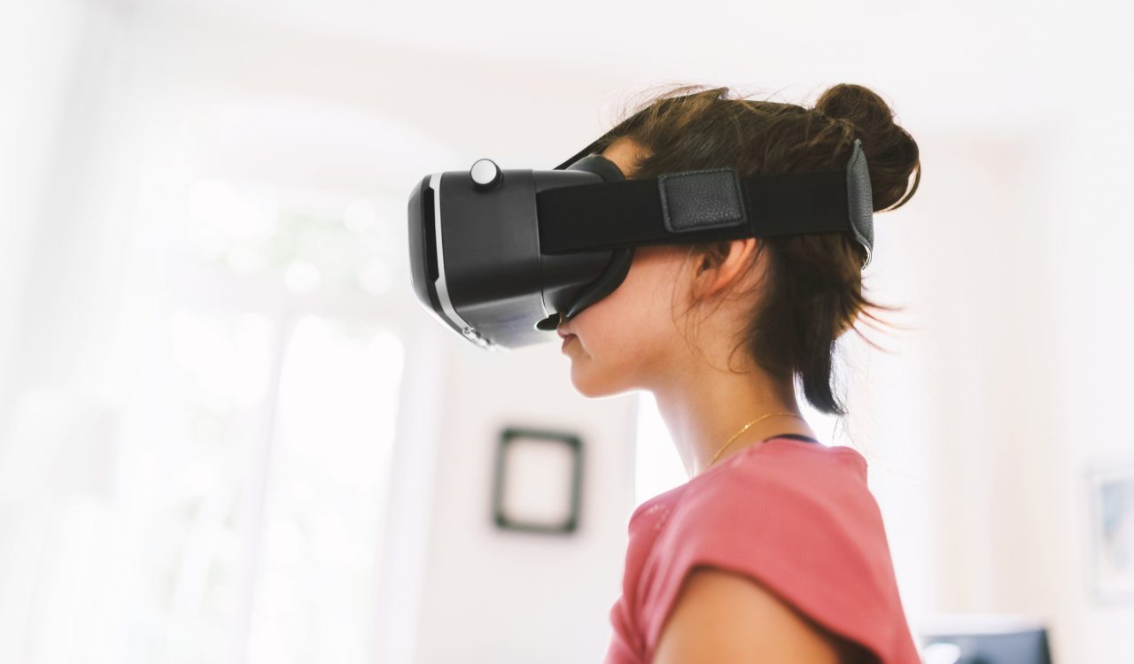 A young girl wears a virtual reality headset