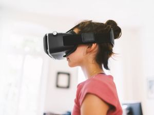 A young girl wears a virtual reality headset