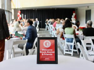 Close-up of a welcome sign on a table at an event.