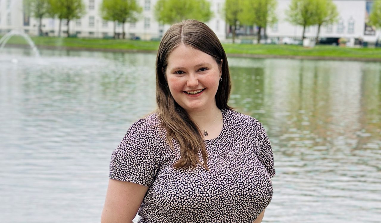 Alison Randell in front of a large fountain and pool.