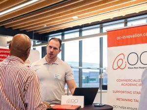 Two people talk at a networking event.