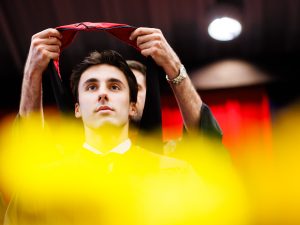 A graduate receives their hood during the convocation ceremony.