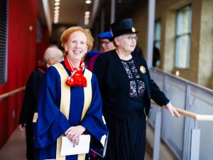 University officials smile while preparing to enter the ceremony.