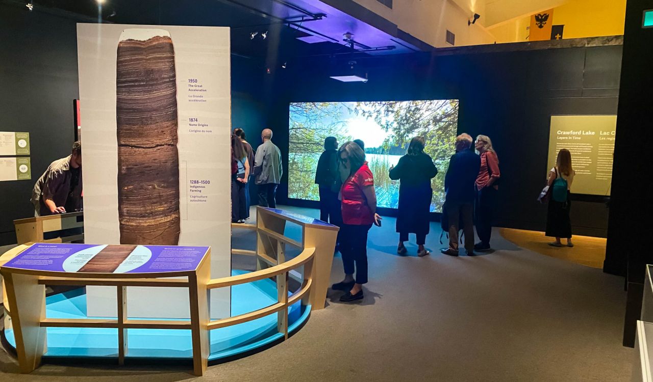 People look at items in a museum exhibit.