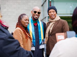 Three people stand together and smile for a picture during Brock University's 118th Convocation.