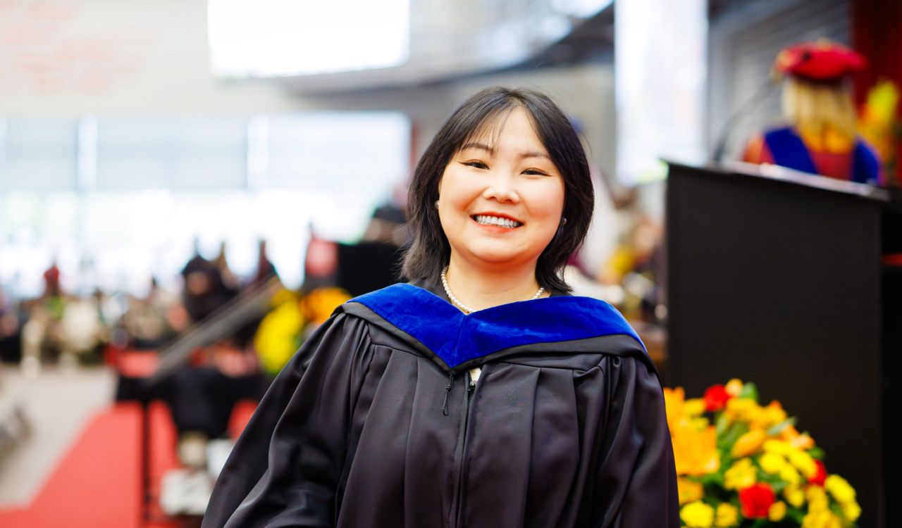 Yanan Liu (MBA '25) crosses the stage at Fall Convocation in Ian Beddis Gymnasium on Friday, Oct. 17.