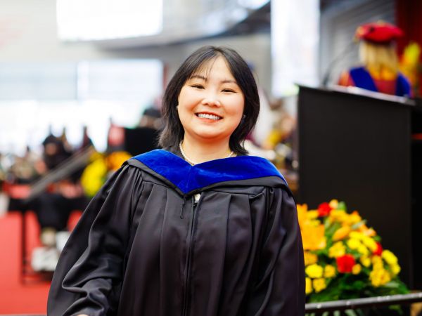 Yanan Liu (MBA '25) crosses the stage at Fall Convocation in Ian Beddis Gymnasium on Friday, Oct. 17.