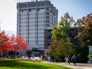 Visitors stroll across Brock University’s campus near the Schmon Tower on a bright fall day.