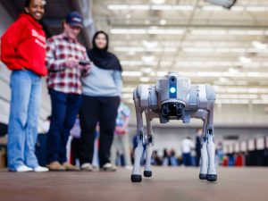 A robot dog demonstration captures the attention of students and visitors.