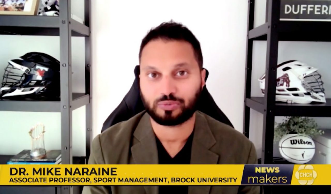 A screenshot of a man speaking during a news broadcast.
