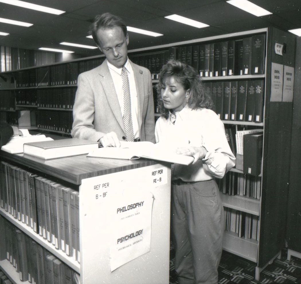 Ian Gordon in the Brock library with patron in 1992.