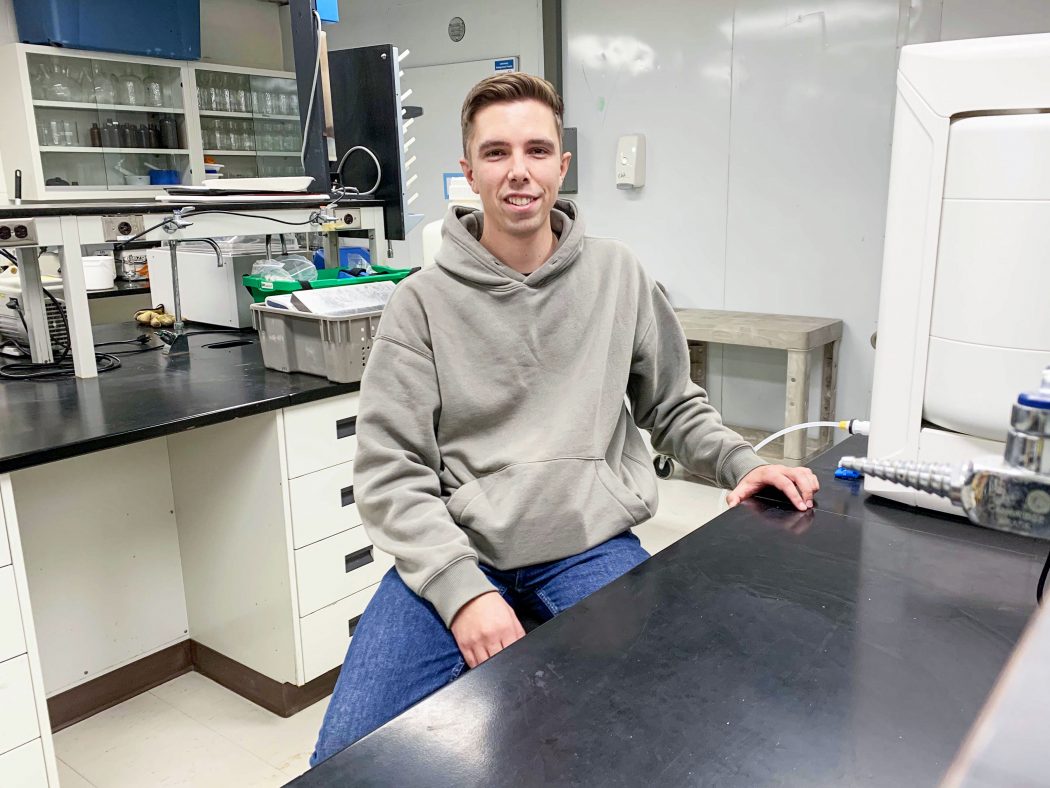 Ben Kapteyn sits in a Brock University lab posing for the camera.