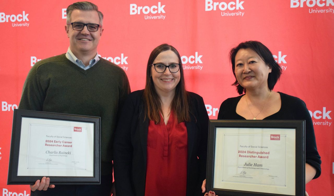 Charlis Raineki, Dawn Zinga and Julie Ham in front of a red Brock backdrop.