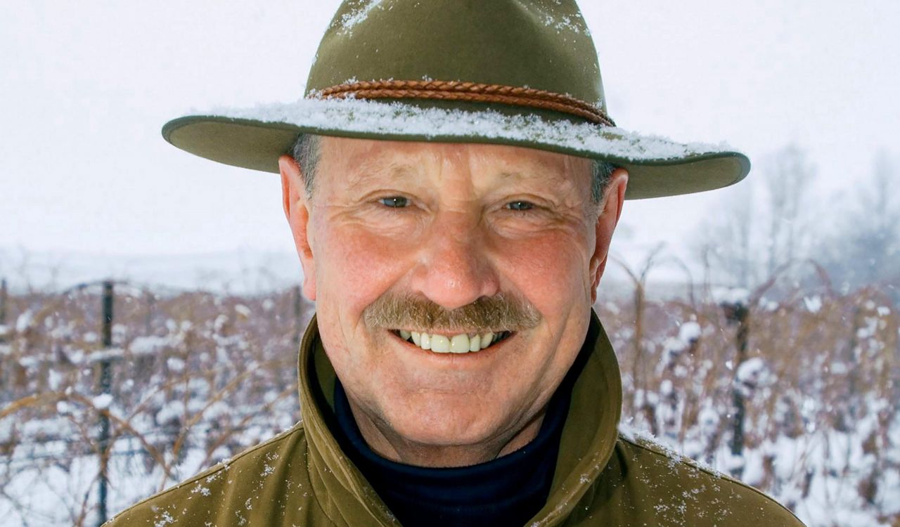 A close-up, outdoor photo of Karl Kaiser in a coat and hat.