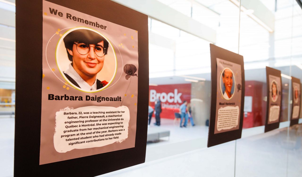 A series of memorial posters hang on a glass wall to remember the 14 women killed in the l'Ecole Polytechnique murders on Dec. 6, 1989.