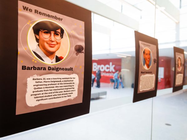 A series of memorial posters hang on a glass wall to remember the 14 women killed in the l'Ecole Polytechnique murders on Dec. 6, 1989.