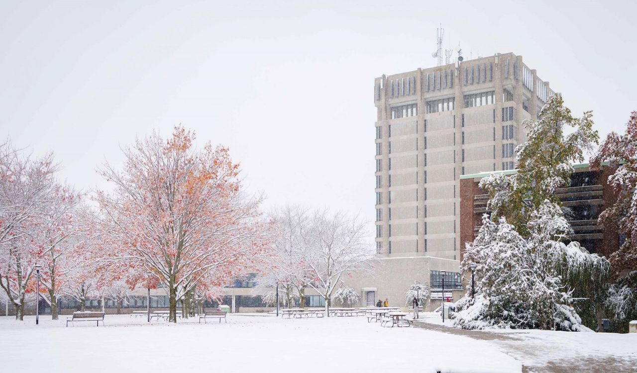 A concrete building on a snowy day.