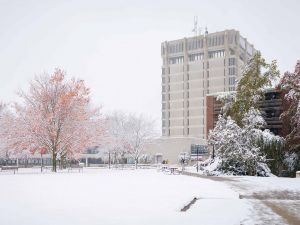 A concrete building on a snowy day.