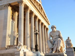 The Austrian Parliament with statue philosopher Thucydides in Vienna, Austria.