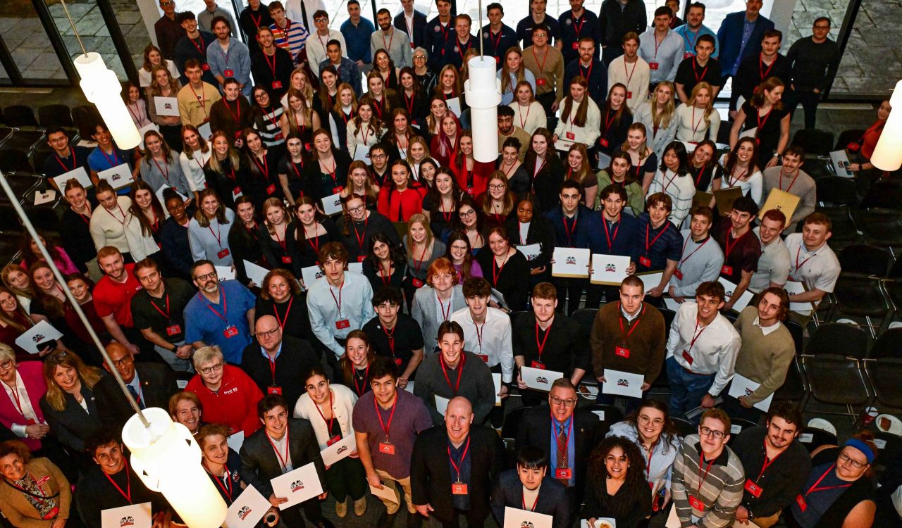 A large group of people pose for a photo at an event.
