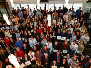 A large group of people pose for a photo at an event.