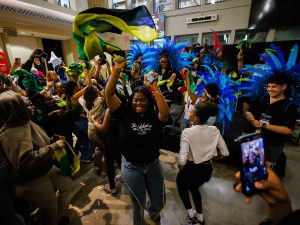 A group of university students dance at a Black History Month event.