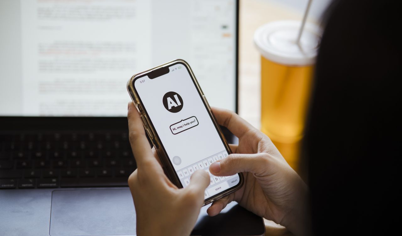 Close-up of someone holding a cellphone with an AI chatbot on the screen.