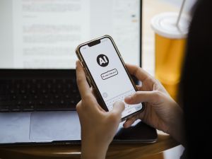 Close-up of someone holding a cellphone with an AI chatbot on the screen.