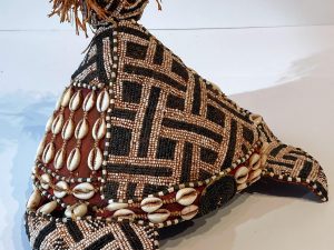 A hat decorated with beads is shown set against a white background.
