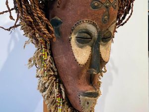 A decorative mask is shown set against a white background.