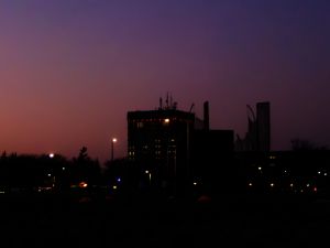 Nighttime image of Brock University with low lighting and purple and pink sky.