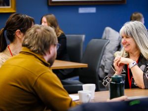 Two people chat at a business event.