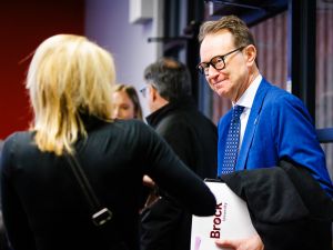 Two people chat at a business event.