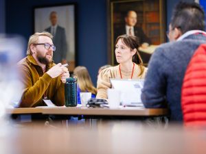 Two people chat at a business event.