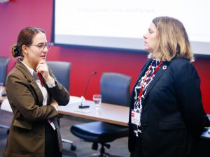 Two people chat at a business event.