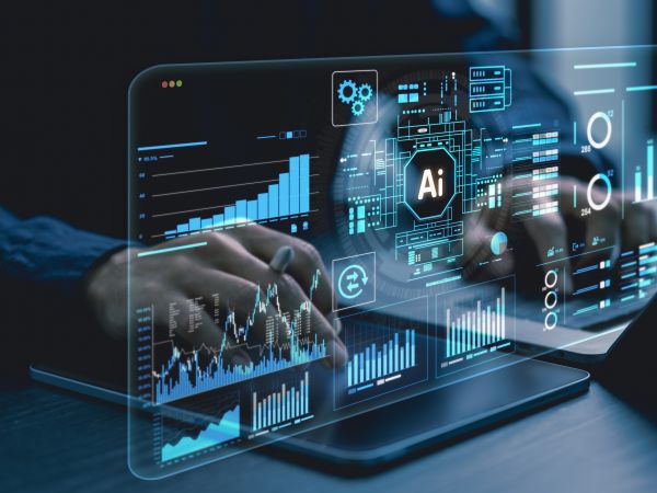 Close-up view of hands typing on a computer with AI and technology images hovering in the foreground,