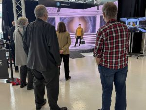 People watch while another person is filmed using high-tech equipment.