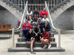A group of students pose on a large staircase in Kingston Penitentiary.