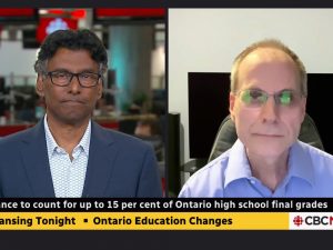 Two men do a virtual television interview in split screen mode.
