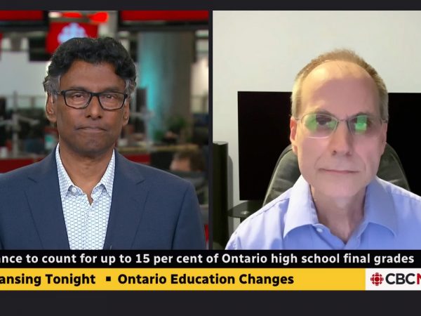 Two men do a virtual television interview in split screen mode.